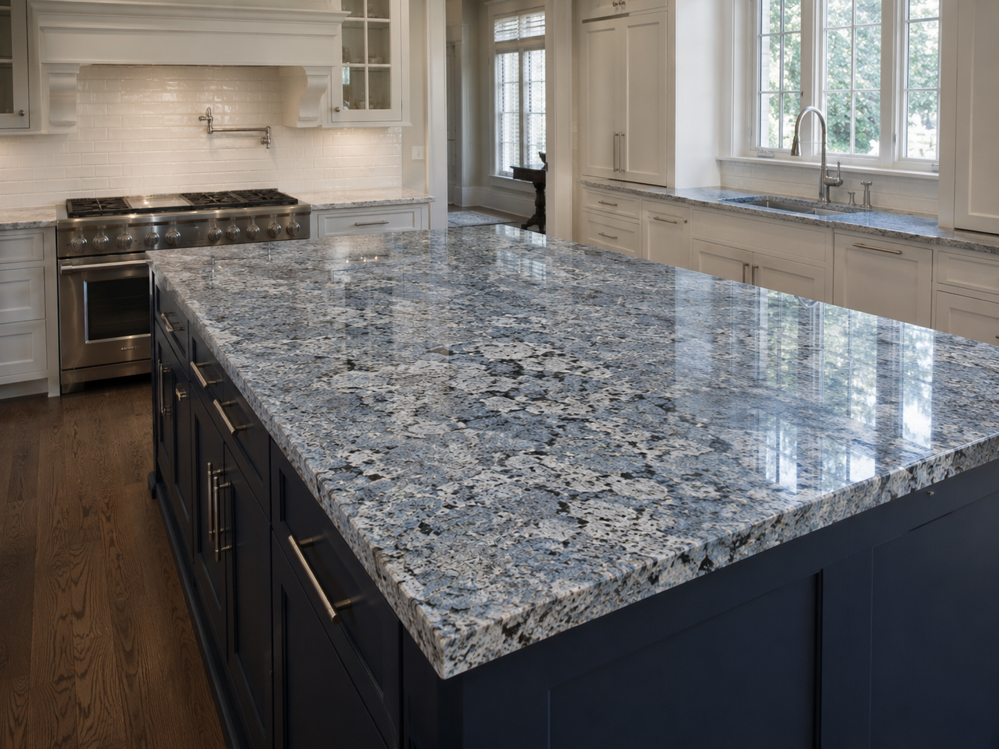 Blue granite kitchen island with navy cabinetry